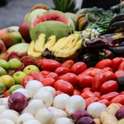 Produce for sale in the back of a pickup truck.