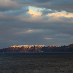 Oia in the distance atop Santorini.