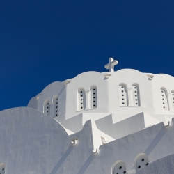 The white buildings are stunning against the blue sky.