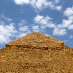 The top section has many casing stones still in place. The pyramids were all covered in smooth limestone casing stones that now litter the bases as they have fallen off or been used for other building througout the centuries.